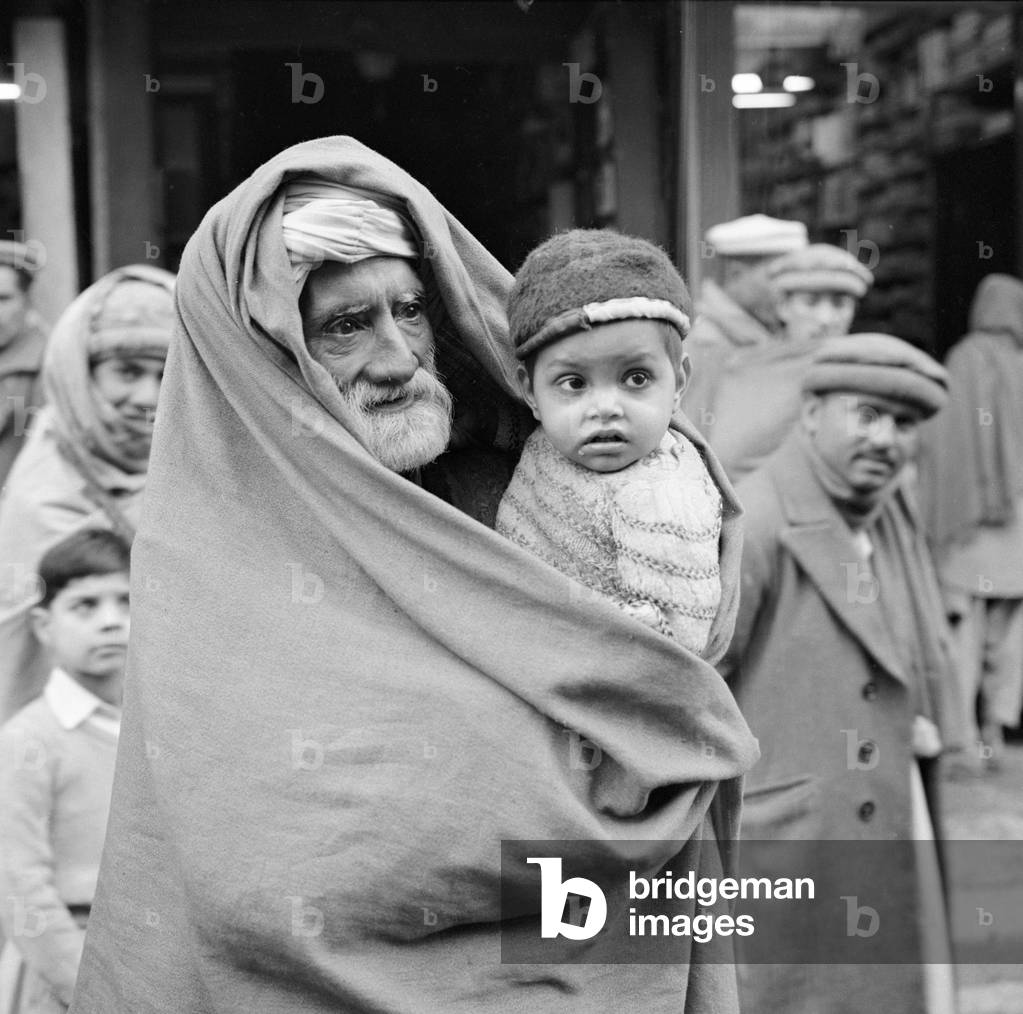 A grandfather and his grandson seen here on the streets of Peshawar the capital of the North West Frontier province of Pakistan, February 1961 (b/w photo)
