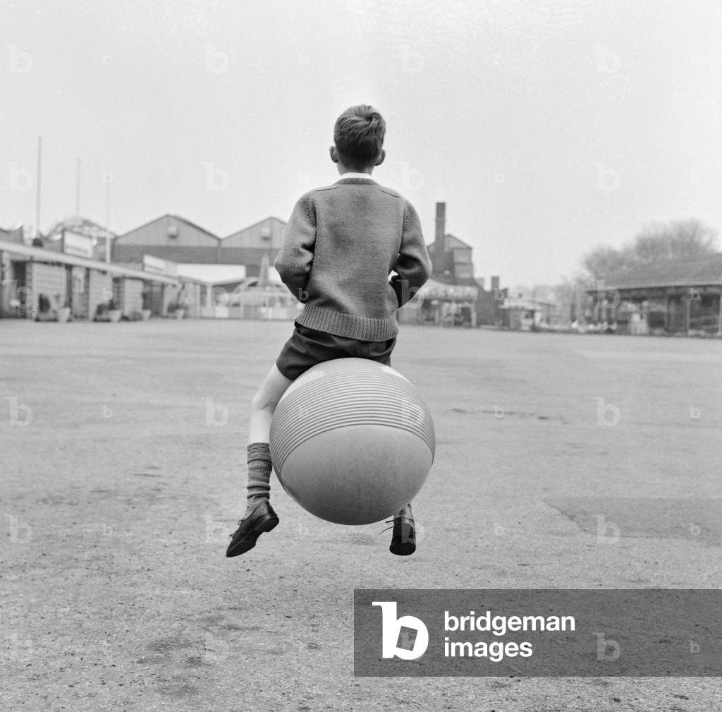 Nine year old Peter Scott from West Derby, Liverpool, playing outside on his kangaroo ball, 17th April 1967 (b/w photo)