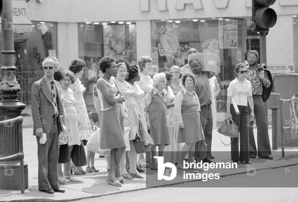 Brixton Community shoppers at lunch time crossing the Brixton Road by the Underground Station
June 1976