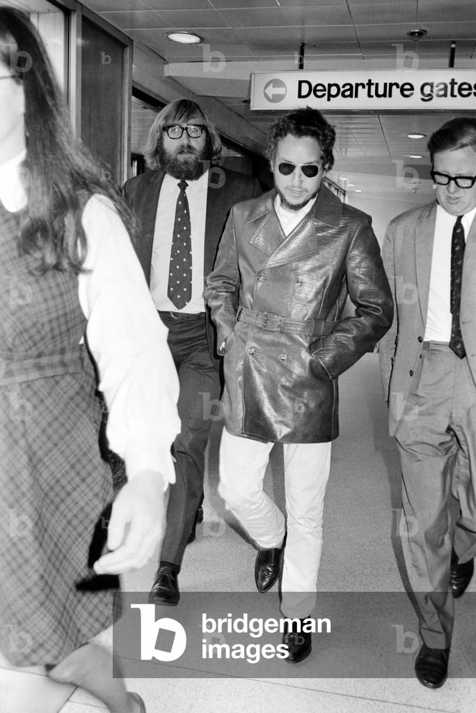 American folk singer, Bob Dylan and his wife left Heathrow Airport today to return home to the USA, September 1969 (b/w photo)