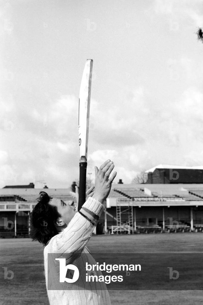 Cricketer Derek Randall and his repertoire of tricks photographed at Trent Bridge as he prepares for the new season. Balancing and juggling the cricket bat, April 1977 (b/w photo)