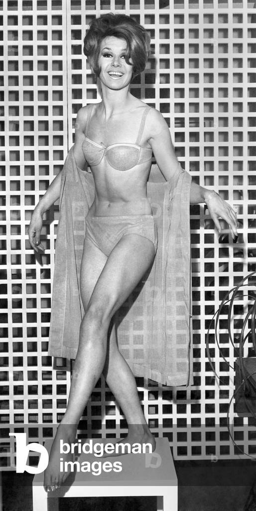 Clothing Beach. Model shows bikini and sheer wrap. March 1963 P017972