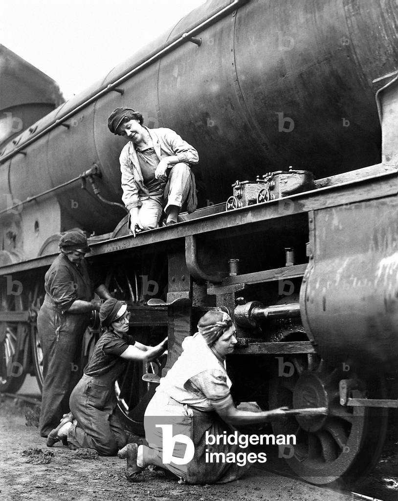 Women working on train cleaning engine, 27th August 1942 (b/w photo)