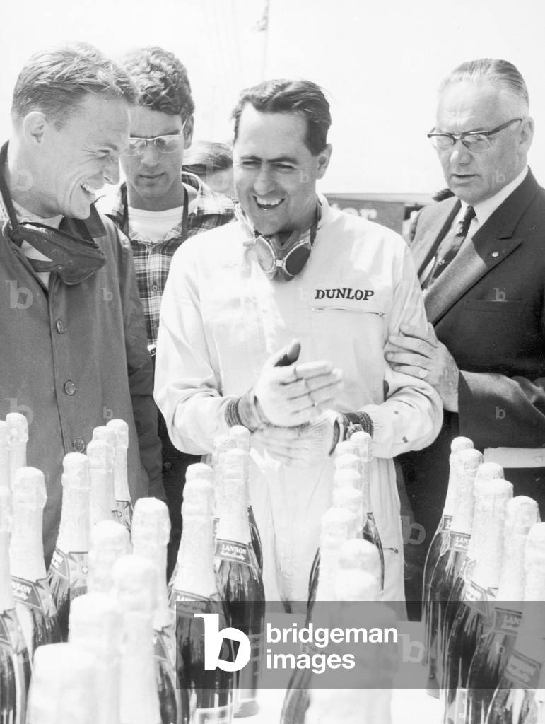 Racing driver Jack Brabham seen here celebrating 9th July 1964 (b/w photo)