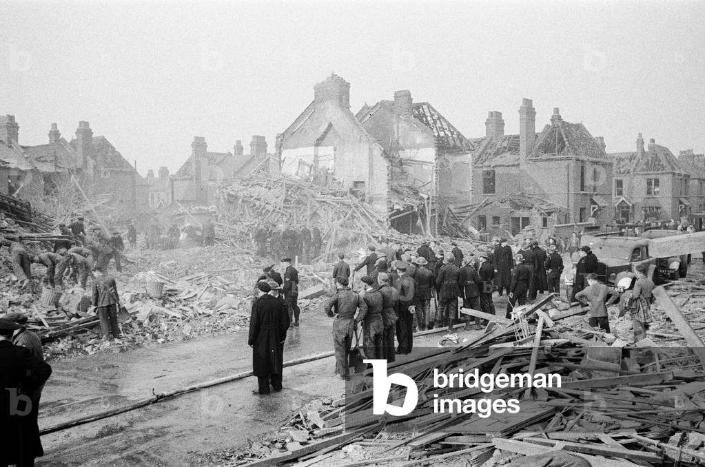 V2 Rocket incident at Farrant Avenue, Lordship Lane, Wood Green. Dogs helping search for survivors. 3rd March 1945 (b/w photo)