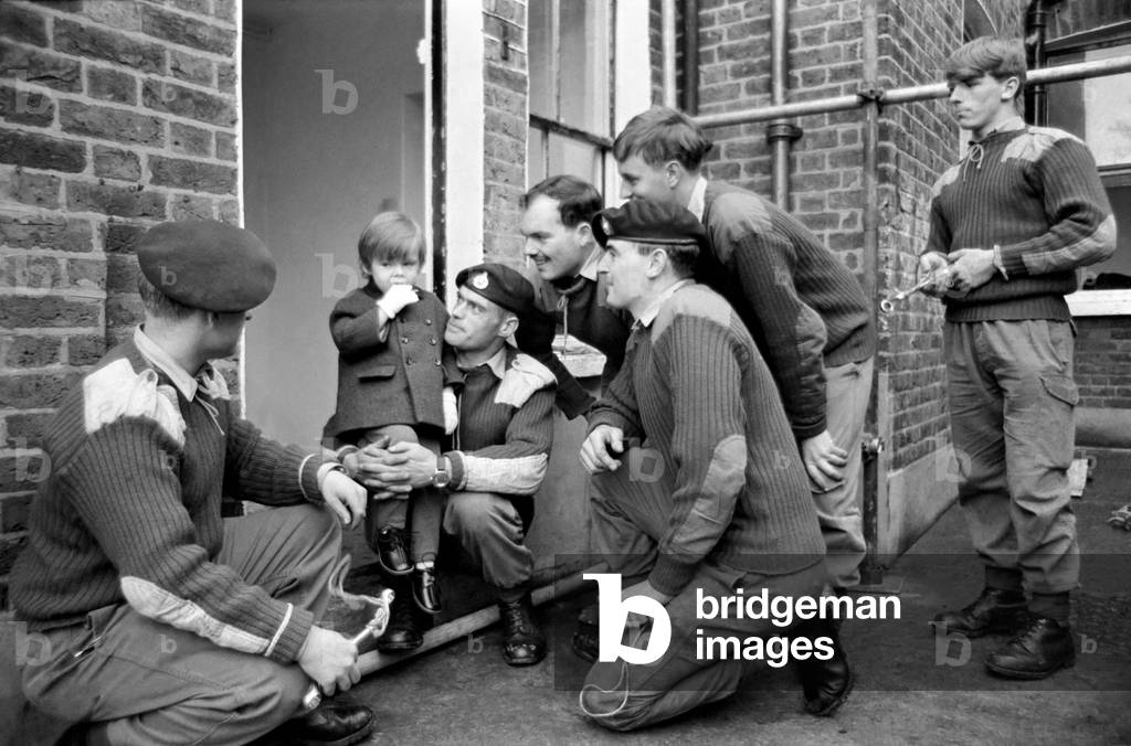 Mark Diment meets the six marines who are working on his special play area, at the Chancellor Grove, West Norwood home where he will soon be moving. November 1969