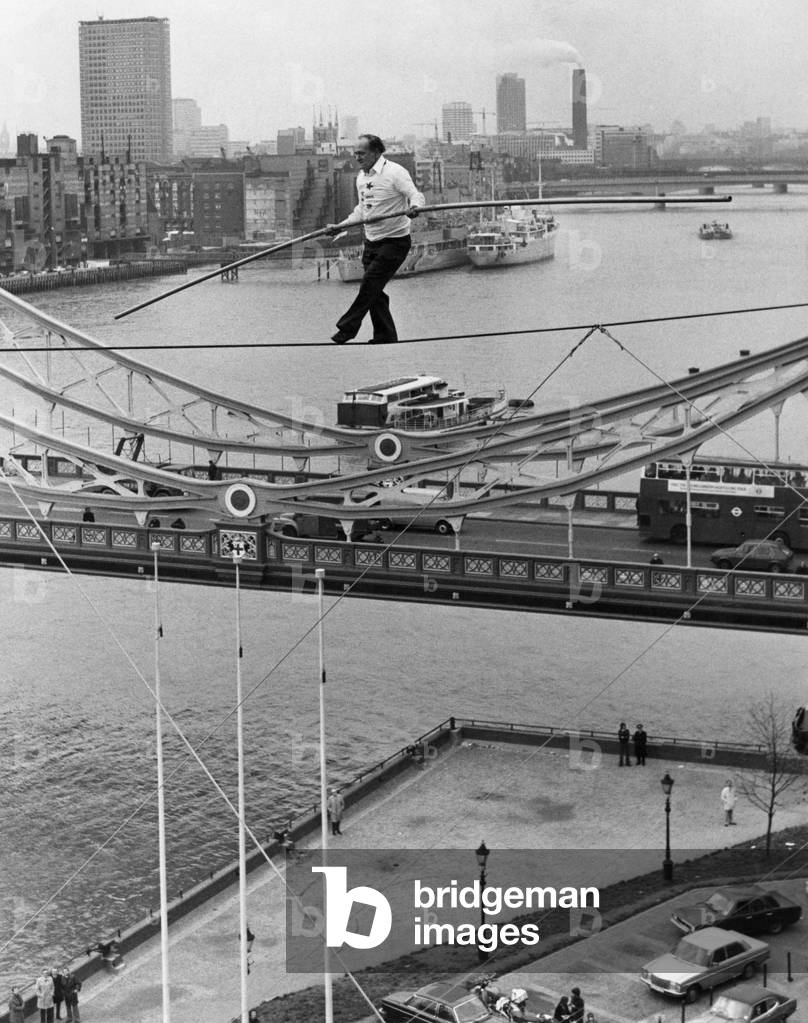 Karl Wallenda successfully walks 100 feet above the ground near Tower Bridge, London today. 
November 1976