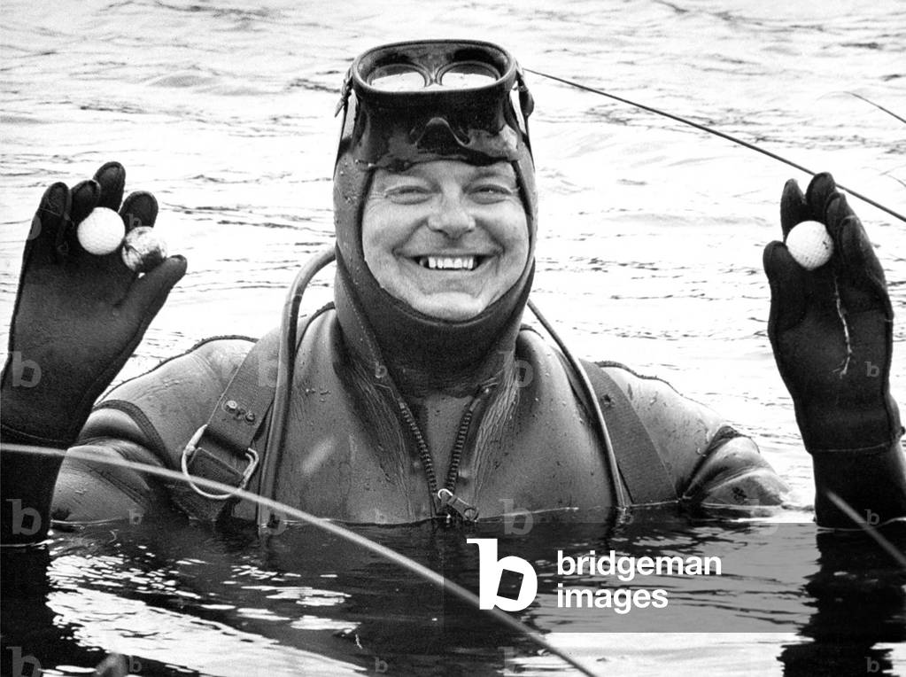 Brian Powton wears flippers adn an aqualung for the 10th hole of his local golf course. Brian's underwater collections make him popular with the youngsters at Seahouses Golf Club. Since he first plunged into the disused quarry on the seaside course he has retrived thousands of balls, which can be used by the club's junior members, 1970