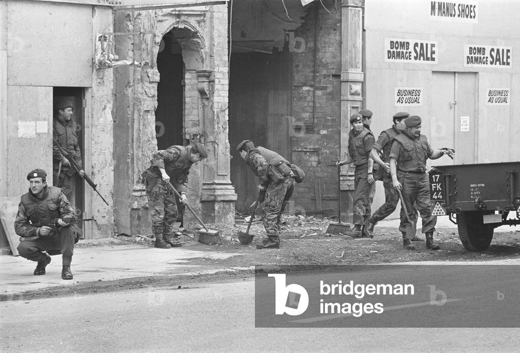 Soldiers from the Scots Guard seen here sweeping the streets of Londonderry following an explosion in the centre of town. 6th August 1972 (b/w photo)