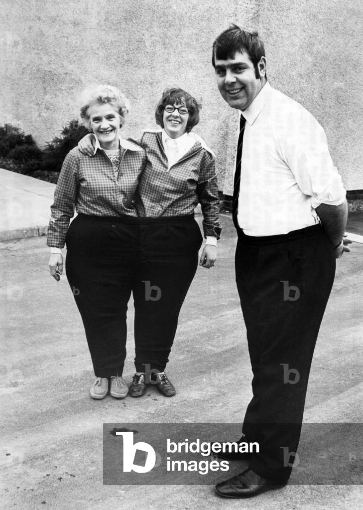 The new slimline Hugh. In the background his sister Diane (left) and her friend Ella Scott both manage to get into a pair of trousers he wore before he lost weight. 
February 1972