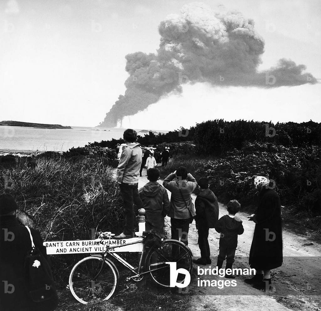 Royal Naval Buccaneer Jets blast stricken tanker Torrey Canyon and set the sea on fire seen from nearest point sixteen miles away of Cape Cornwall, March 1967 (b/w photo)
