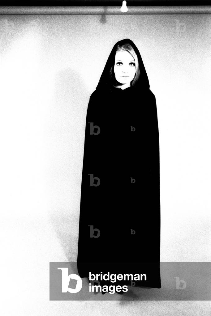 A model wears a cloak for a fashion shoot, 13th April 1970 (b/w photo)