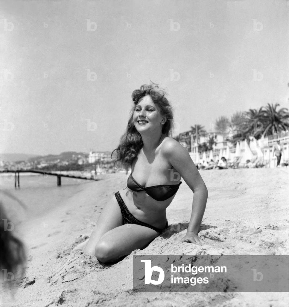 Holiday Maker Simone Gervais on the beach at Cannes Film Festival, April 1953 (b/w photo)