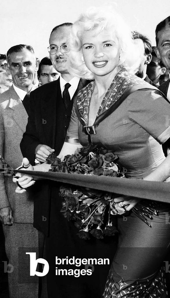 Jayne Mansfield cuts red tape at ceremony in London September 1959 (b/w photo)