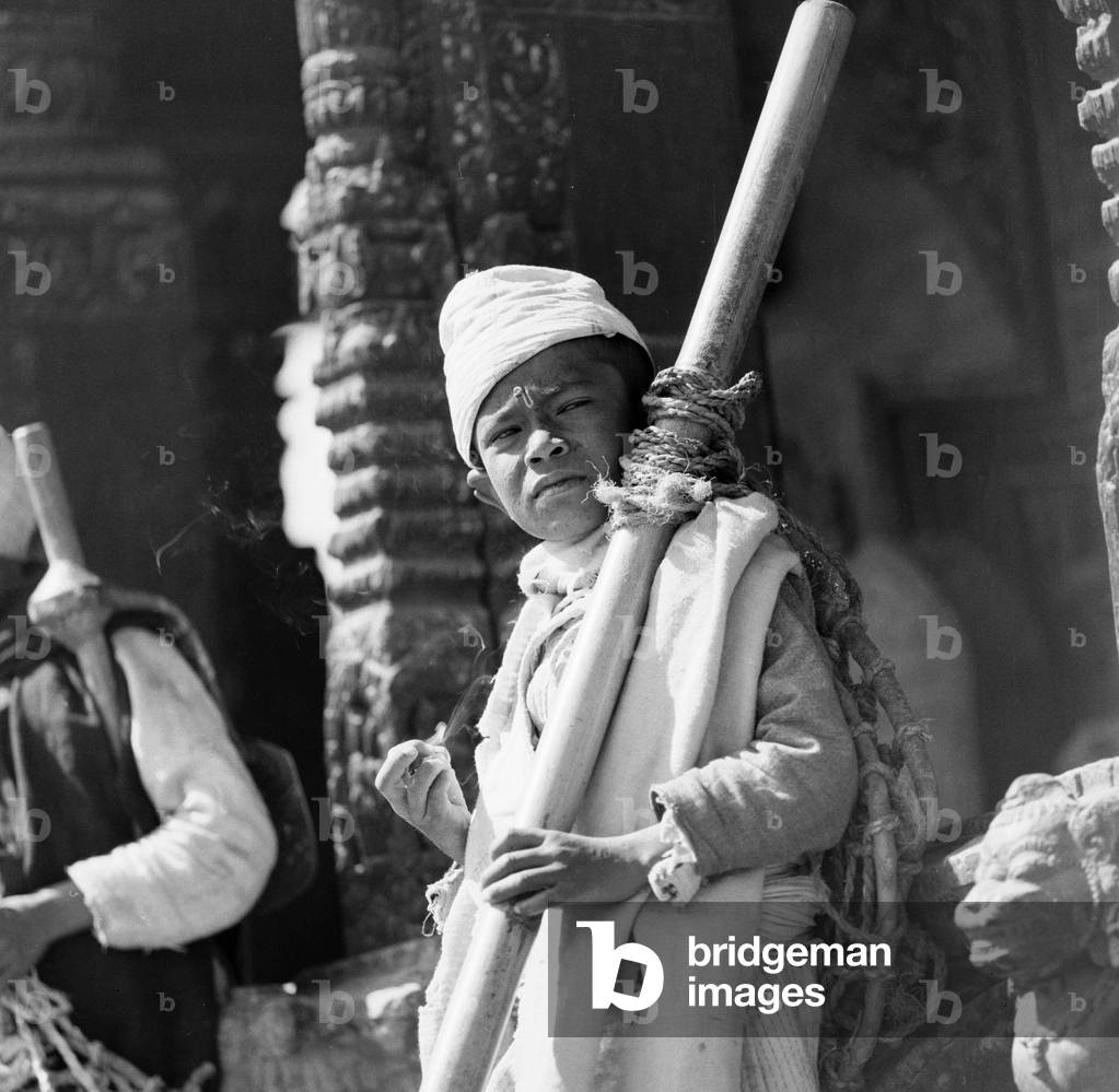 A Nepalese market trader seen here in Durbar Square, Katmandu outside a Buddhist temple in the mountain kingdom of Nepal, February 1961 (b/w photo)