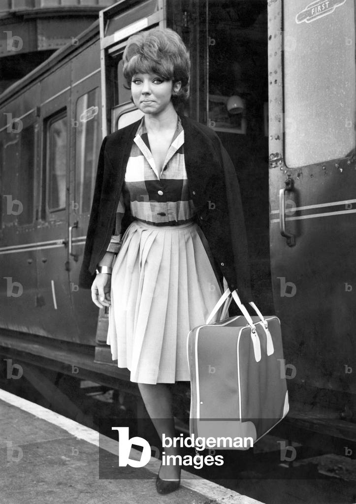 21-year old Dilys Watling photographed at Manchester Central Station, October 1964 (b/w photo)