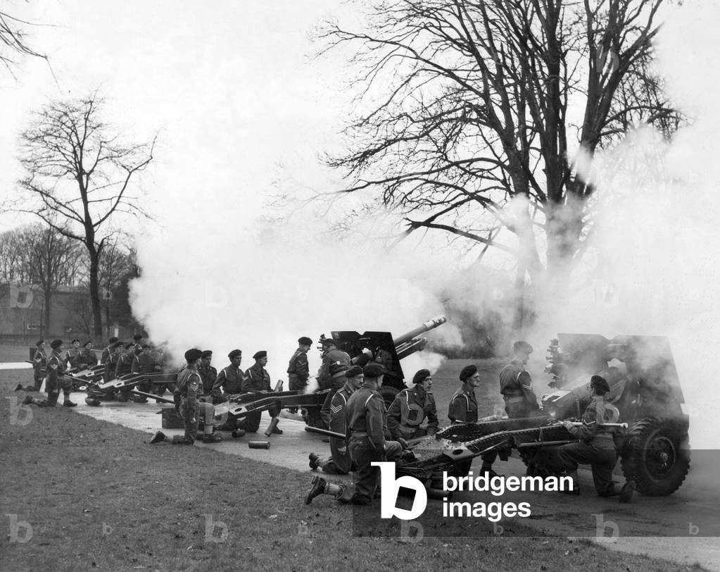 A Royal Salute of 21 guns is fired by the 281 Glamorgan Yeomanry Field Regiment, R. A. (T. A.), in the Castle Grounds, Cardiff, Wales, 20th February 1960 (b/w photo)