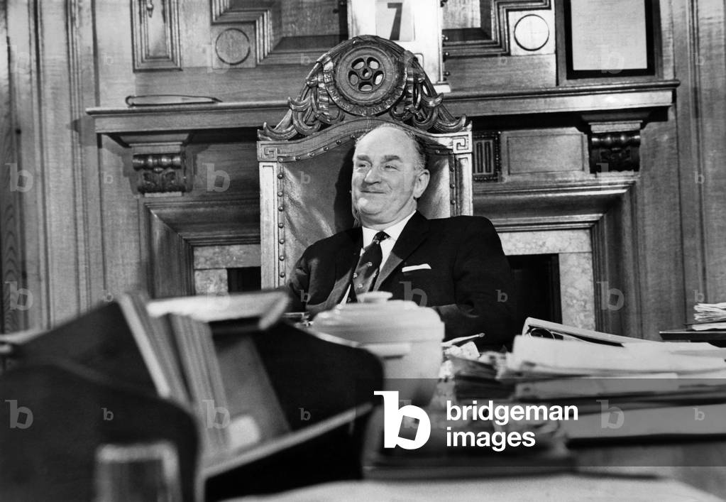 Hugh Scanlon, who has been elected to succeed Lord Carron as president of the Amalgamated Engineering Union, seen here trying out the president's chair, November 1967 (b/w photo)