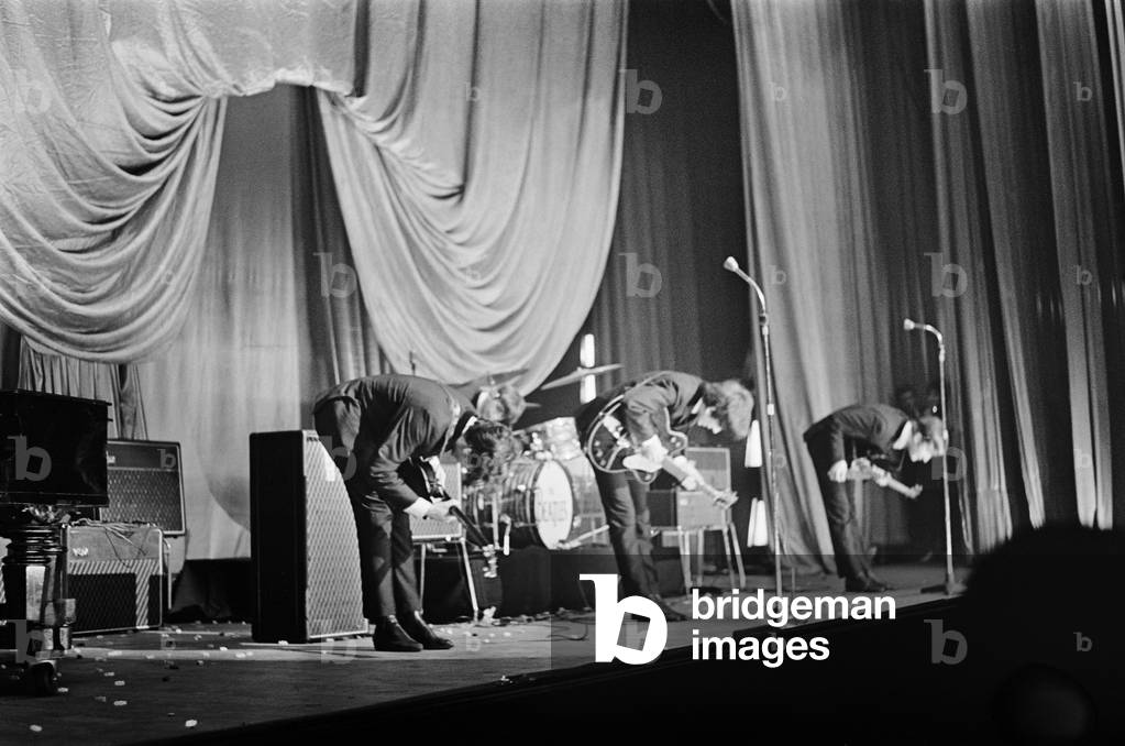 The Beatles take a bow on stage in Carlisle at the end of their concert. 21st November 1963.