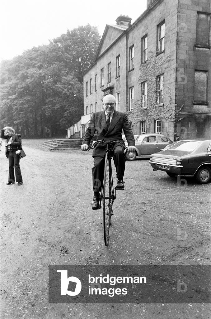 Mr Philip Yorke takes a trip around the grounds of his house on a Penny Farthing. He has been trying to give away his family home for five years, and now the National Trust has decided to take the house, full of priceless treasures, including the Penny Farthing, Erdigg Hall, Wrexham, North Wales, 29th May 1973 (b/w photo)