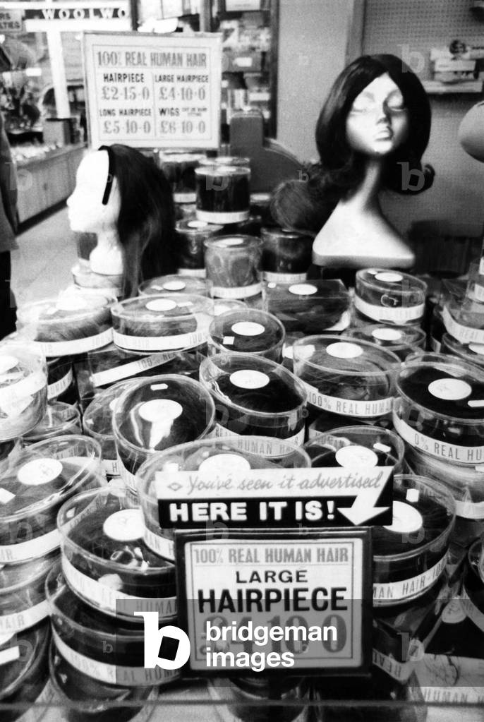 Wigs, the New Line at Woolworths: Once upon a time, a girl needed to be bald to buy a wig. Or prepared to dish out £100 on a status symbol. Duchesses, films stars and models plus a few ladies in need of a disguise, perhaps woolies, 08/12/1967 (b/w photo)