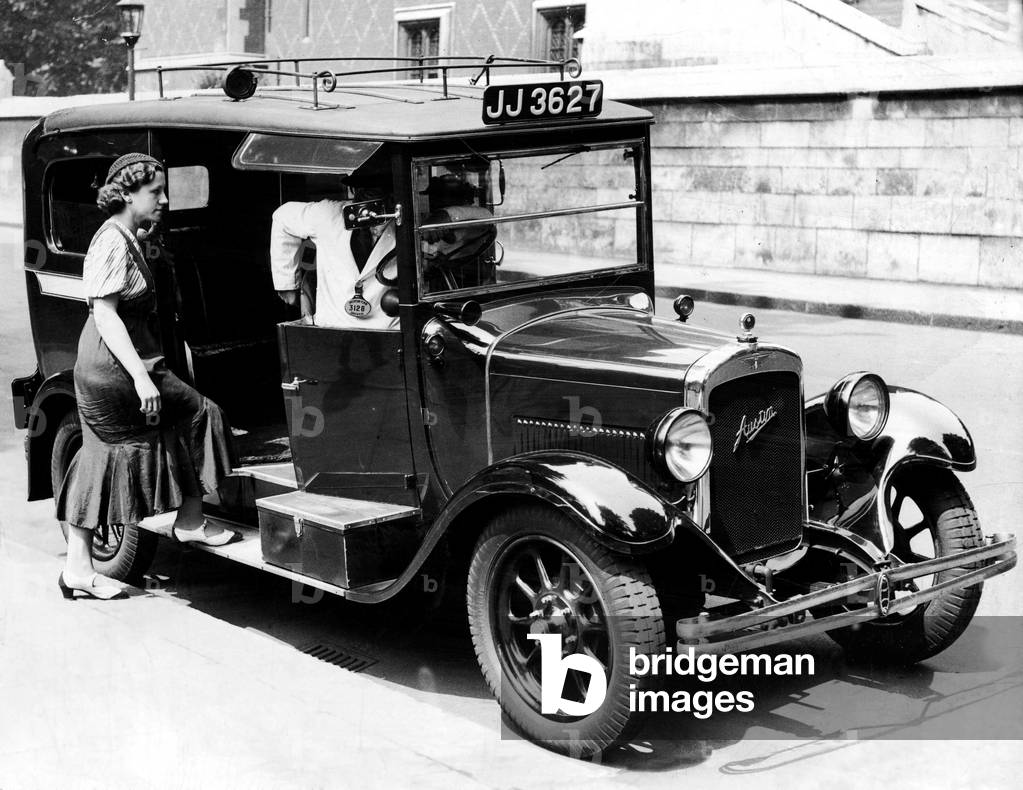A female passenger entering one of the new London taxi cabs that can travel up to 50 miles per hour. 18th June 1933 (b/w photo)