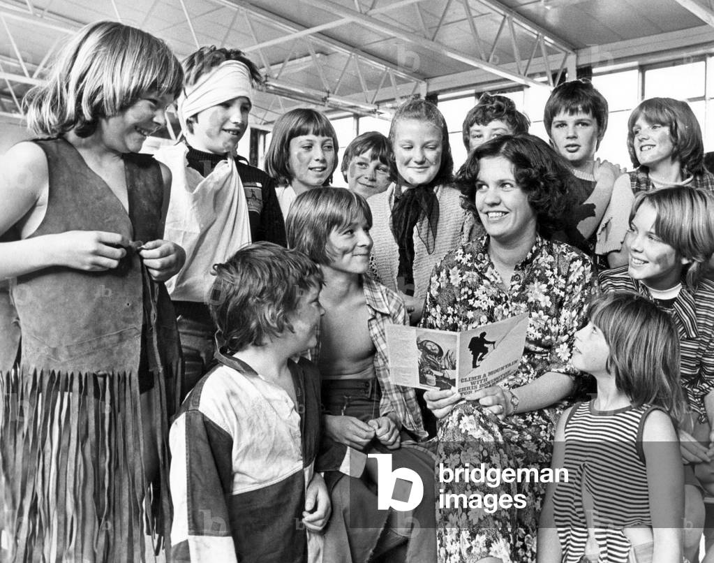 Pupils of Low Grange School, Billingham dress up to present a cheque of 260 pounds to Mrs. Jane Kellie, area organiser for Dr. Barnardo's. The money was raised in just one week by pupils who collected donations from family and friends after Mrs Kellie gave a talk on Barnardo's orphanages to the school. 12th October 1978 (b/w photo)