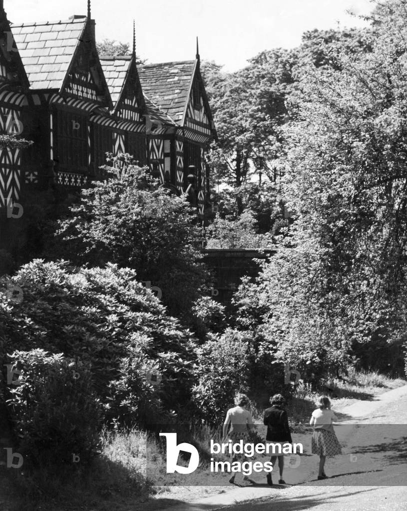 Three friends out for a walk at Speke Hall, the 16th century wood framed wattle and daub Tudor manor house in Speke, Liverpool. 9th April 1968 (b/w photo)