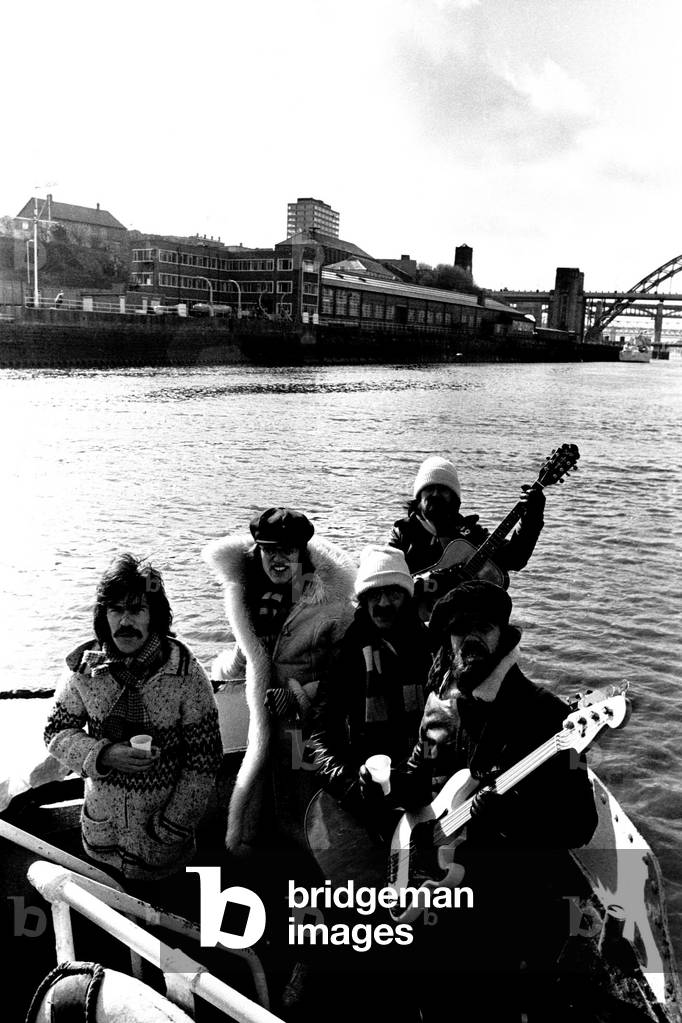 Lindisfarne sailed down the Tyne on a musical journey. The group were filming on board a Tyne ferry for a half-hour television show called 'All Right Now'. (Left to right) Ray Jackson, Ray Laidler, Alan Hull, Si Cowe and Rod Clements, 4th March, 1979 (b/w photo)