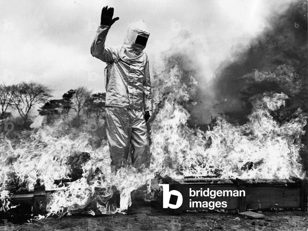 Firefighter Dave Katz walks throught a tunnel of fire to demonstate the fireproof suit, 1970