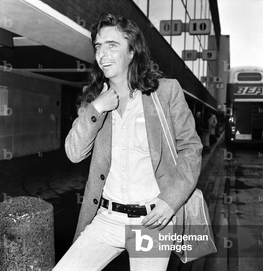 American rock singer Alice Cooper arrives in London ahead of his tour, 15th March 1974 (b/w photo)