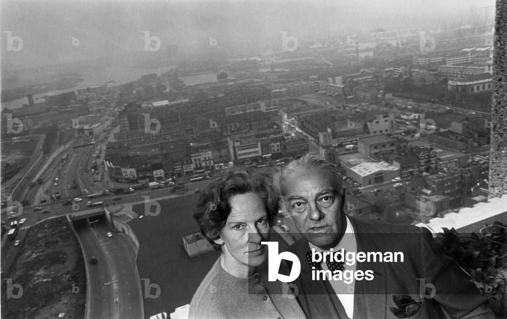 Mr Erno Goldfinger, Hungarian-born architect, moves into a block of GLC flats he designed at the northern approach to Blackwall Tunnel, firstly as a social experiment and to help improve his future designs. Seen here on top of the 24 floor block with his wife Ursula, 22nd February 1968 (b/w photo)