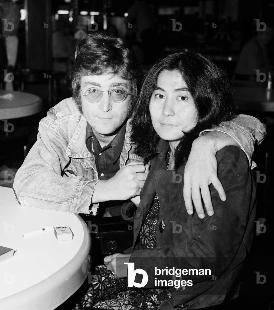 Former Beatle John Lennon with his wife Yoko Ono leaving Heathrow Airport for the Cannes Film festival where two of their films 