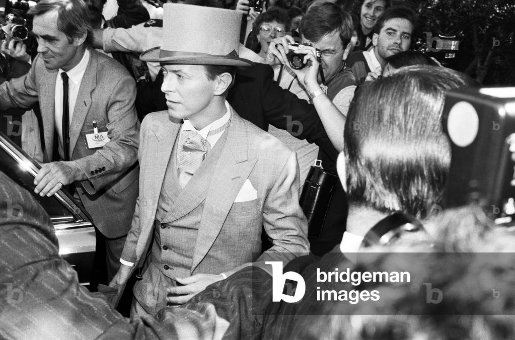 British pop singer David Bowie pictured arriving for the wedding of former Boomtown rats singer Bob Geldof, 24th August 1986 (b/w photo)