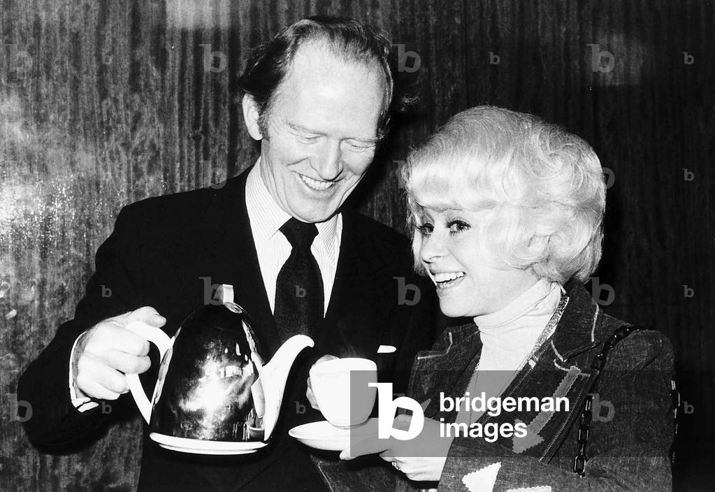 Actor Gordon Jackson pours tea for Barbara Windsor 1976 (b/w photo)