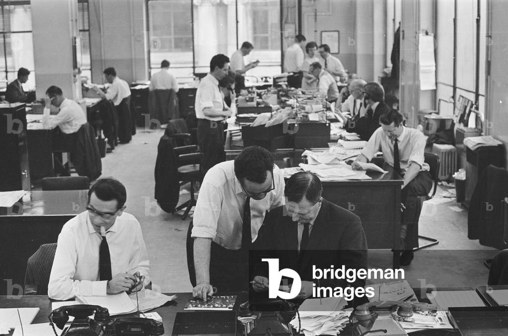 Busy scenes on the Daily Herald news desk, 1964 (b/w photo)