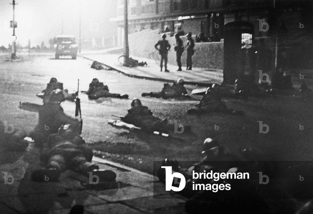 Soldiers of the British Army seek cover after shots were fired in the Shankhill Road Belfast, October 1969