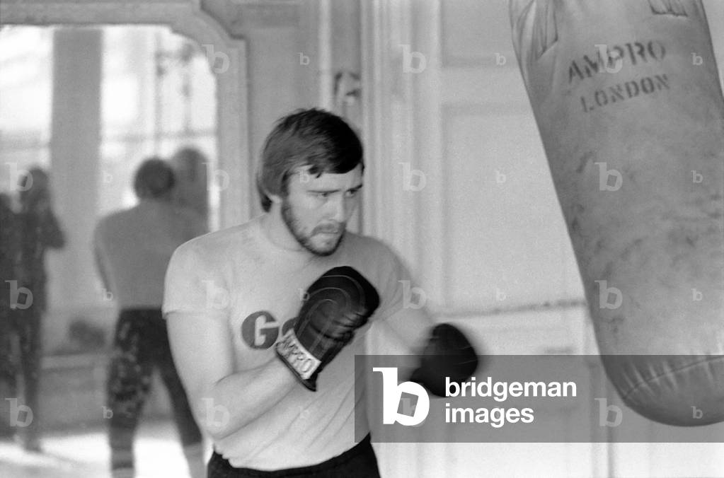 British and European Welterweight Champion John H. Stracey complete with beard at work in the 'Royal Oak' gym Canning Town, March 1975 (b/w photo)