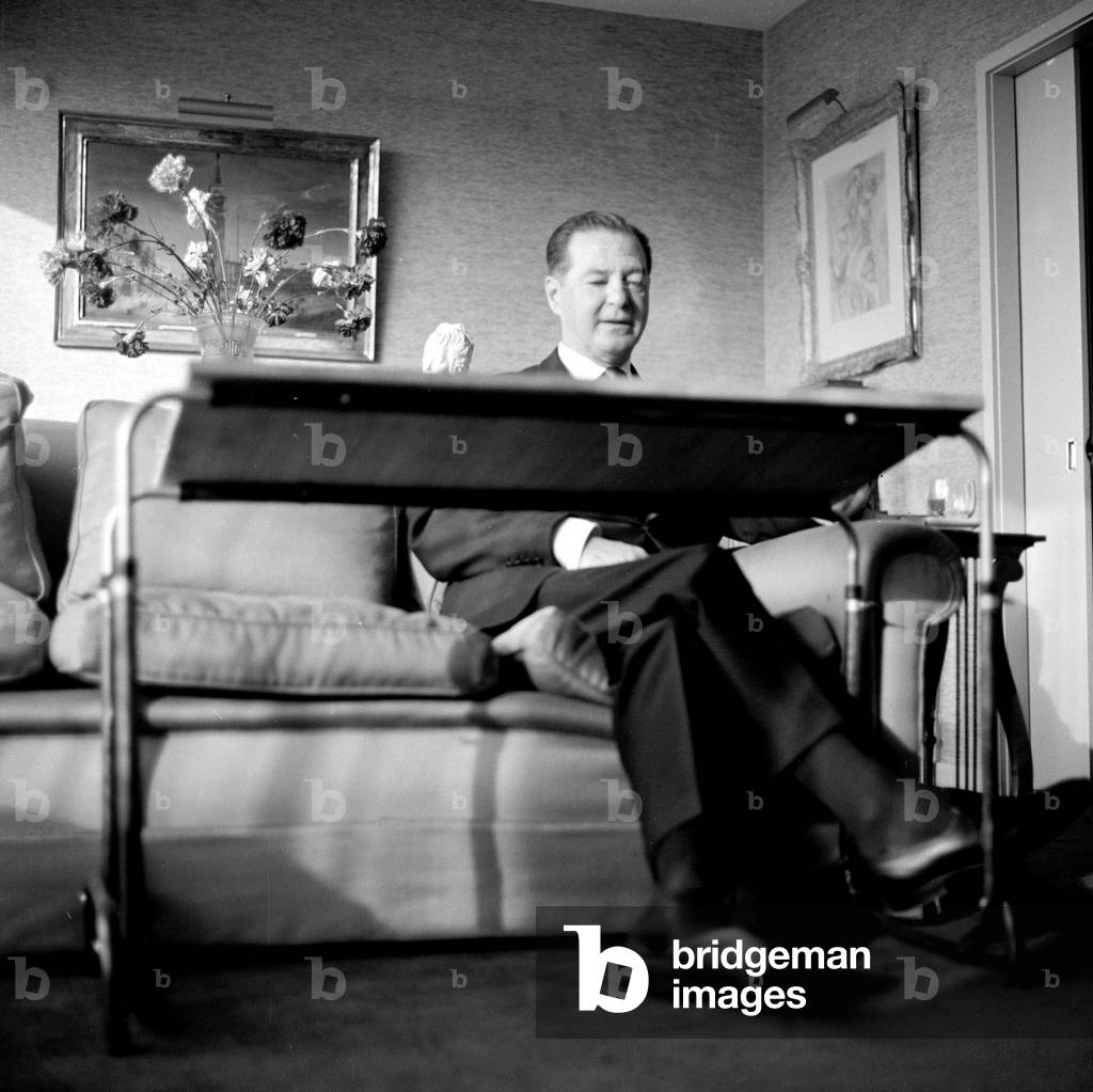 Sir Terence Rattigan, May 1964, Screen Writer. Pictured at home at his London Eaton Square Flat, sitting by his specially designed writing table, 10th June 1911 to 30th November 1977 Appointed a CBE in 1958 and knighted in 1971 (b/w photo)