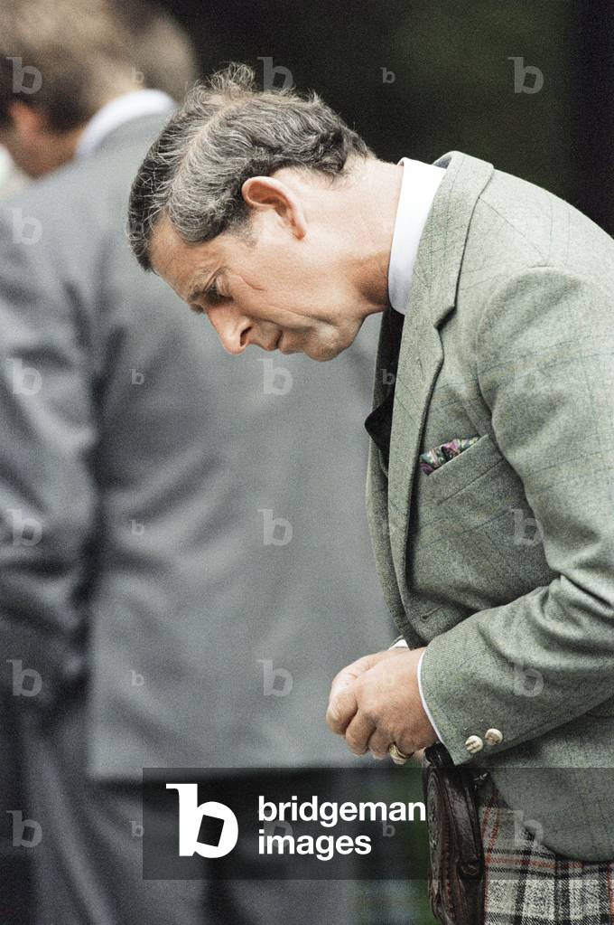 Prince Charles (Future Charles III) looks at floral tributes left for Princess Diana, at the gates of Balmoral Castle, 1997 (photo)