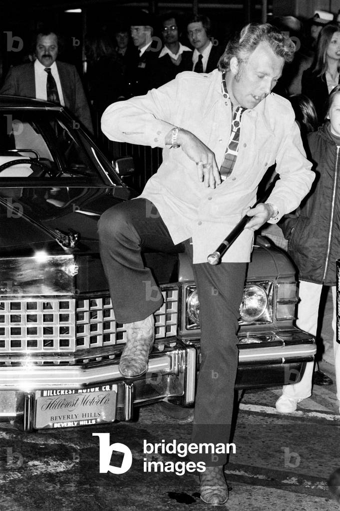 Stuntman Evel Knievel arrives in London ahead of his jump at Wembley Stadium. 6th May 1975 (b/w photo)