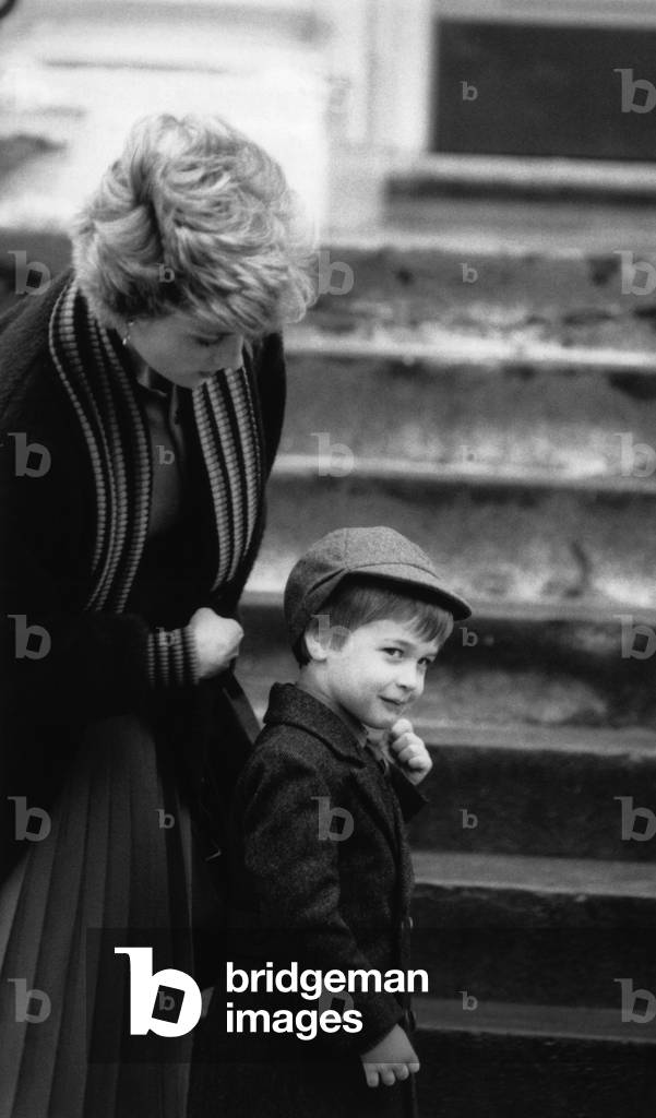 Prince William, aged 4, pictured with mother, Princess Diana, on his first day at Wetherby boys school in London, 15th January 1987 (b/w photo)