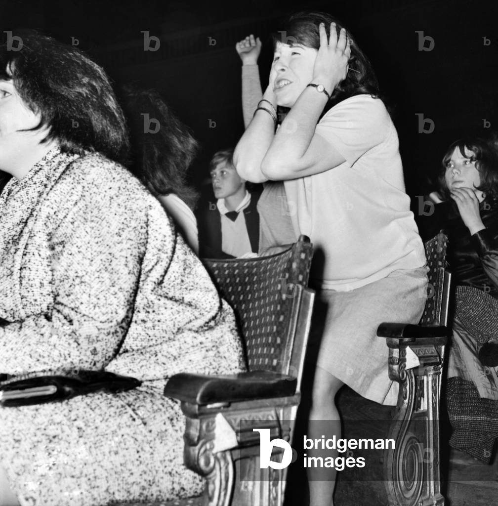 Screaming girl fans greet The Beatles on their appearance at the ABC Cinema in Wigan, 13th October 1964 (b/w photo)