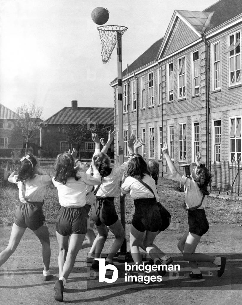 Girls of Malmsbury Secondary School in Morden, Surrey playing a game of netball during P.E, 28th October 1946 (b/w photo)