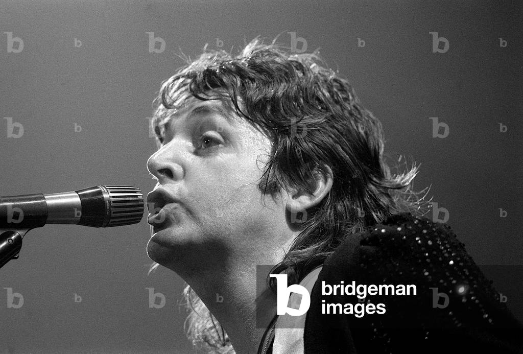 Paul McCartney, formerly of The Beatles, singing with his group Wings in concert in USA, May 1976 (b/w photo)
