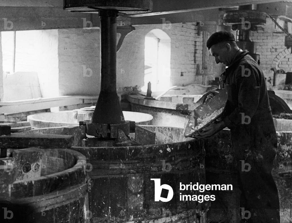 A worker at the Minton China Works in Stoke On Trent, pictured in the mill, where glaze made of borax, lead, stone, whitening and sand and fritted together in a 