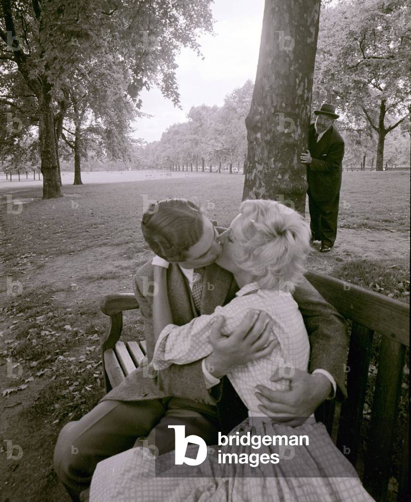 A couple kissing in the park all the while being watched by a dirty old man, 24/08/1960 (b/w photo)