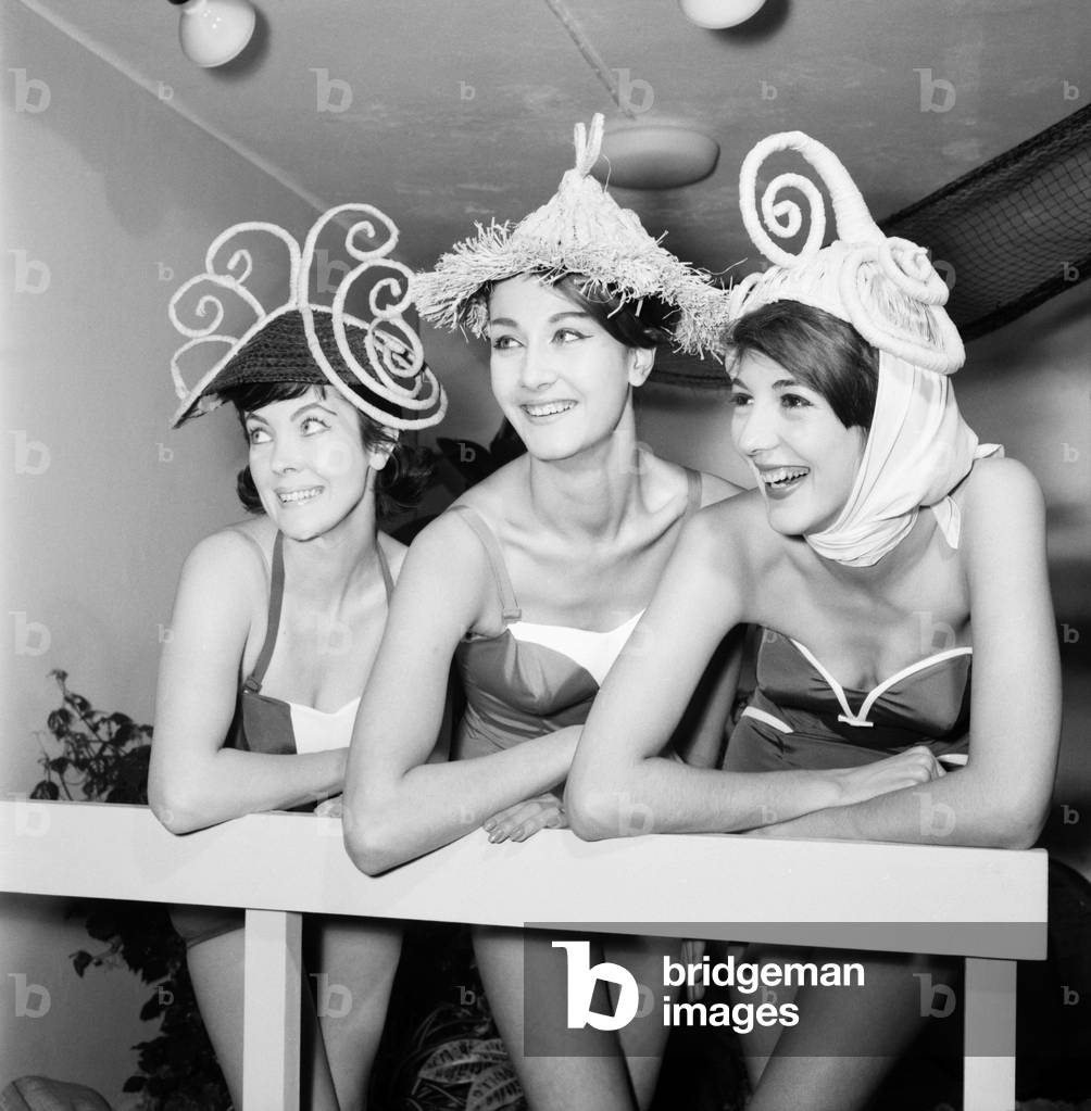 Swimsuit Fashion: Fashion show of Spirella foundation garments and new made-to-measure Swimsuits, was held at Spirella House, Oxford Circus, London. Left to right: Angela Lane, Terry King and Souilla Glass-Hooper, wearing made-to-measure swimsuits and fancy straw beach hats. June 1960 M4240-008