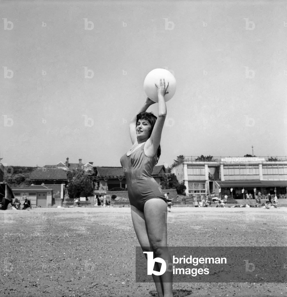 Bathing Girl: Glamour on the Clacton Beach: Jacqueline Wood, 16, Waitress Clacton is cluttering up the Gang Way from the Sky Lark. June 1960