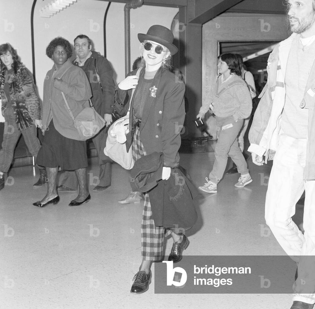 Cyndi Lauper American singer songwriter pictured with manager David Wolff arriving at London Heathrow Airport February 1987 (b/w photo)